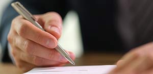 A person writing at a desk